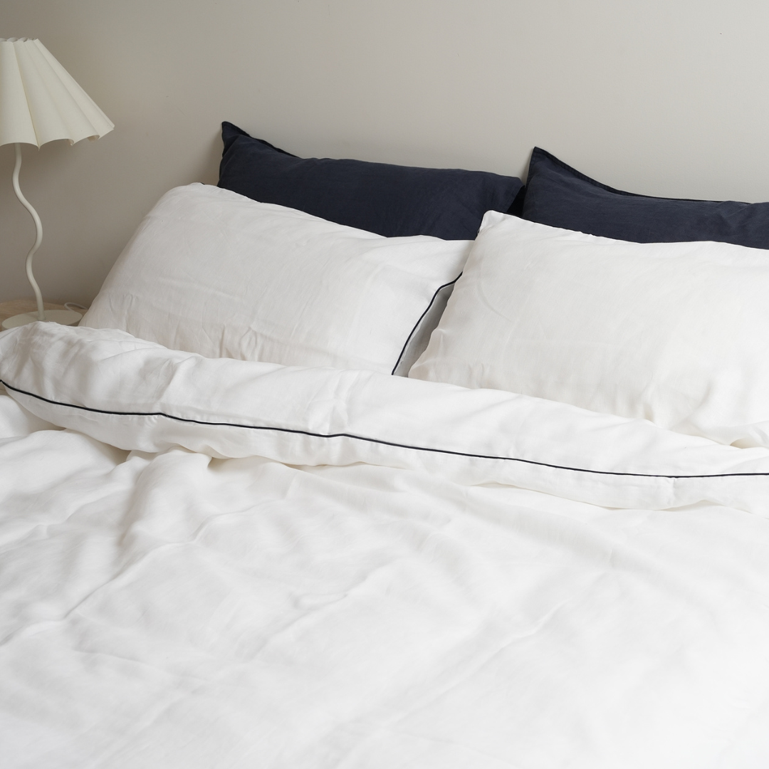 100% french flax linen piped duvet cover set in white/ navy, styled shot
