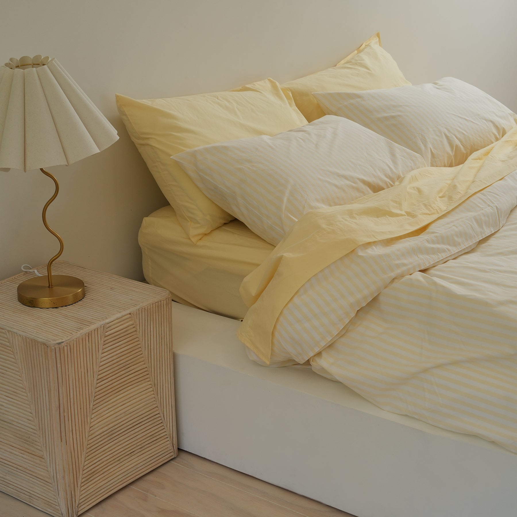 100% stonewashed cotton duvet set in butter stripe, styled shot