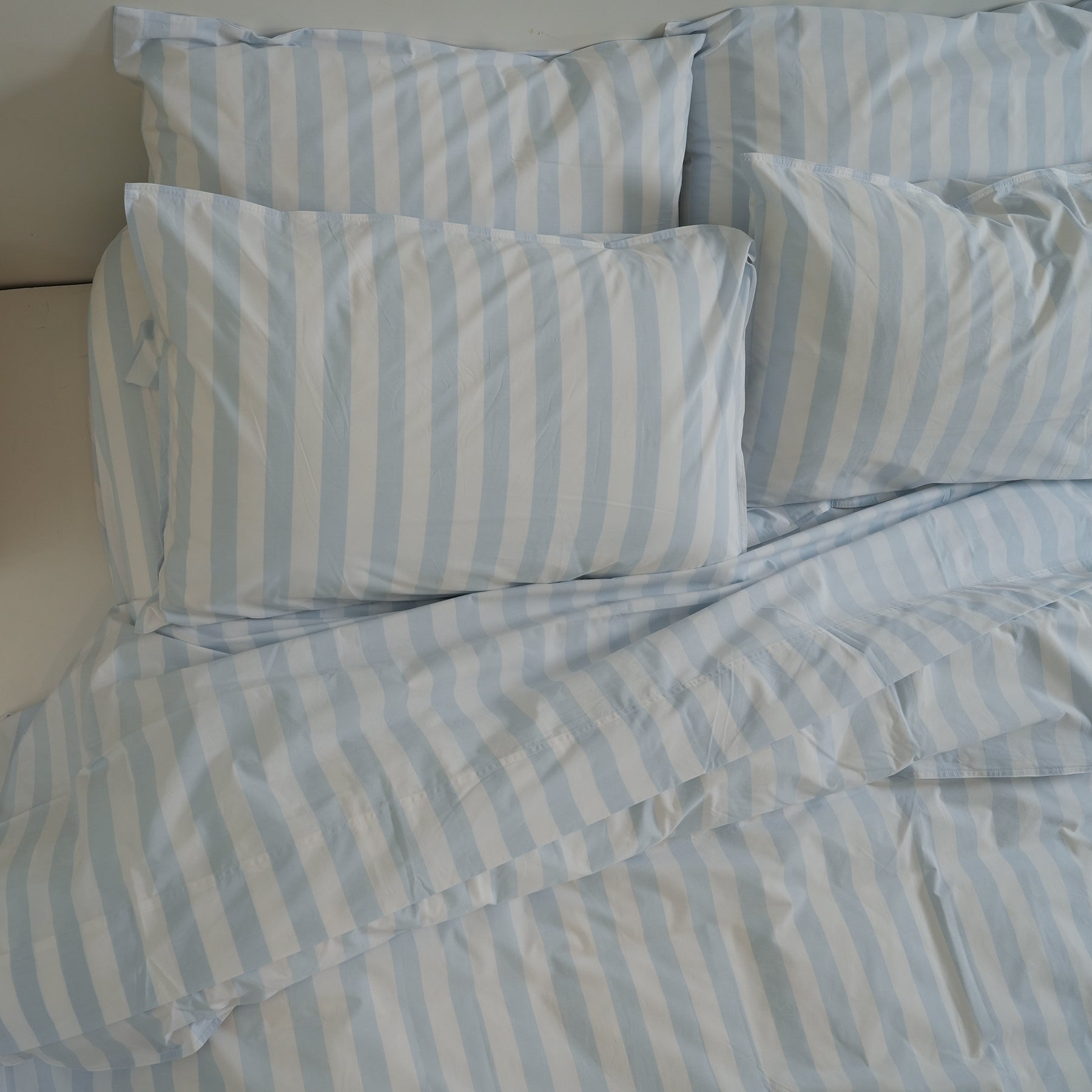 100% stonewashed cotton duvet set in sky blue stripe, styled shot