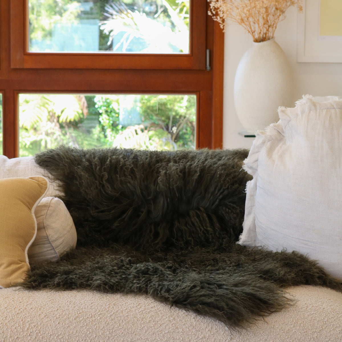 Tibetan lambskin rug in Olive, long curly lambswool pile, side view