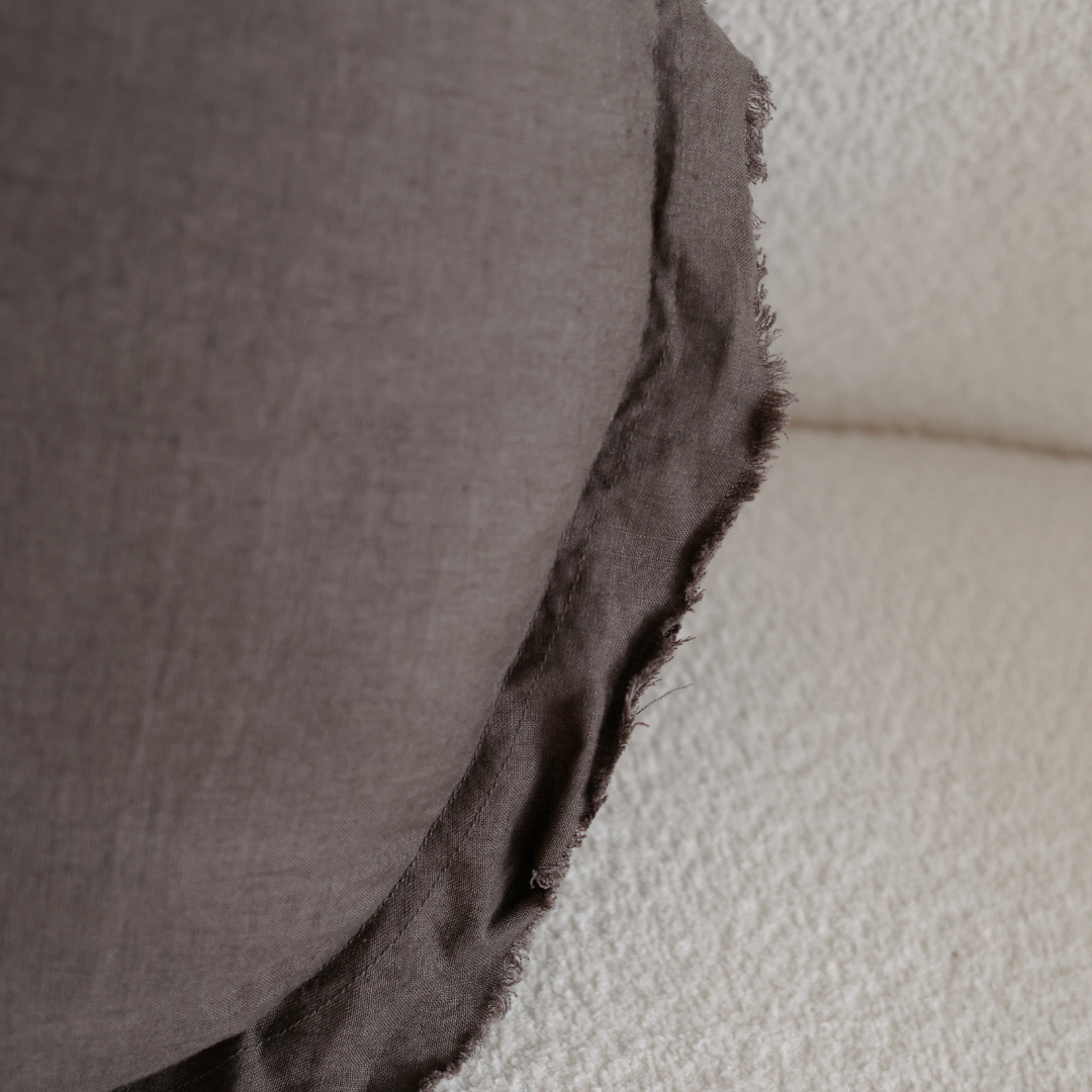 100% flax linen round feather filled cushion in deep moss, styled shot