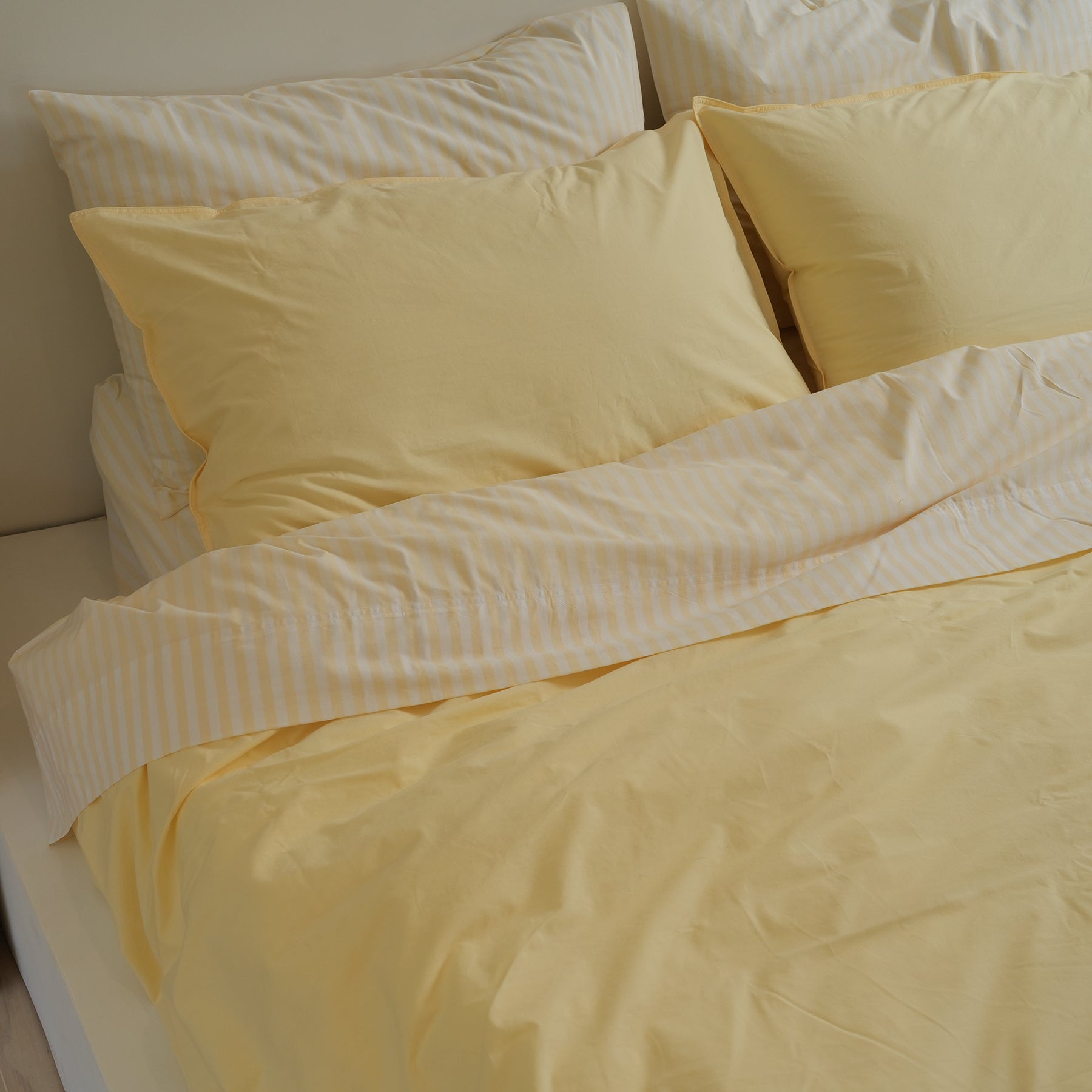 100% stonewashed cotton duvet set in butter, styled shot