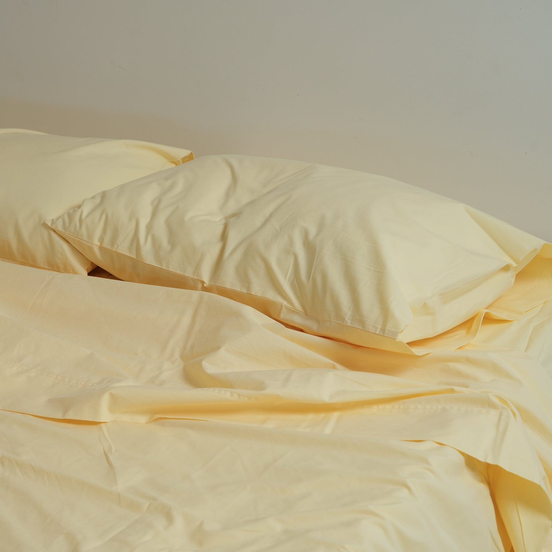 100% stonewashed cotton pillowcase pair in butter, detail view