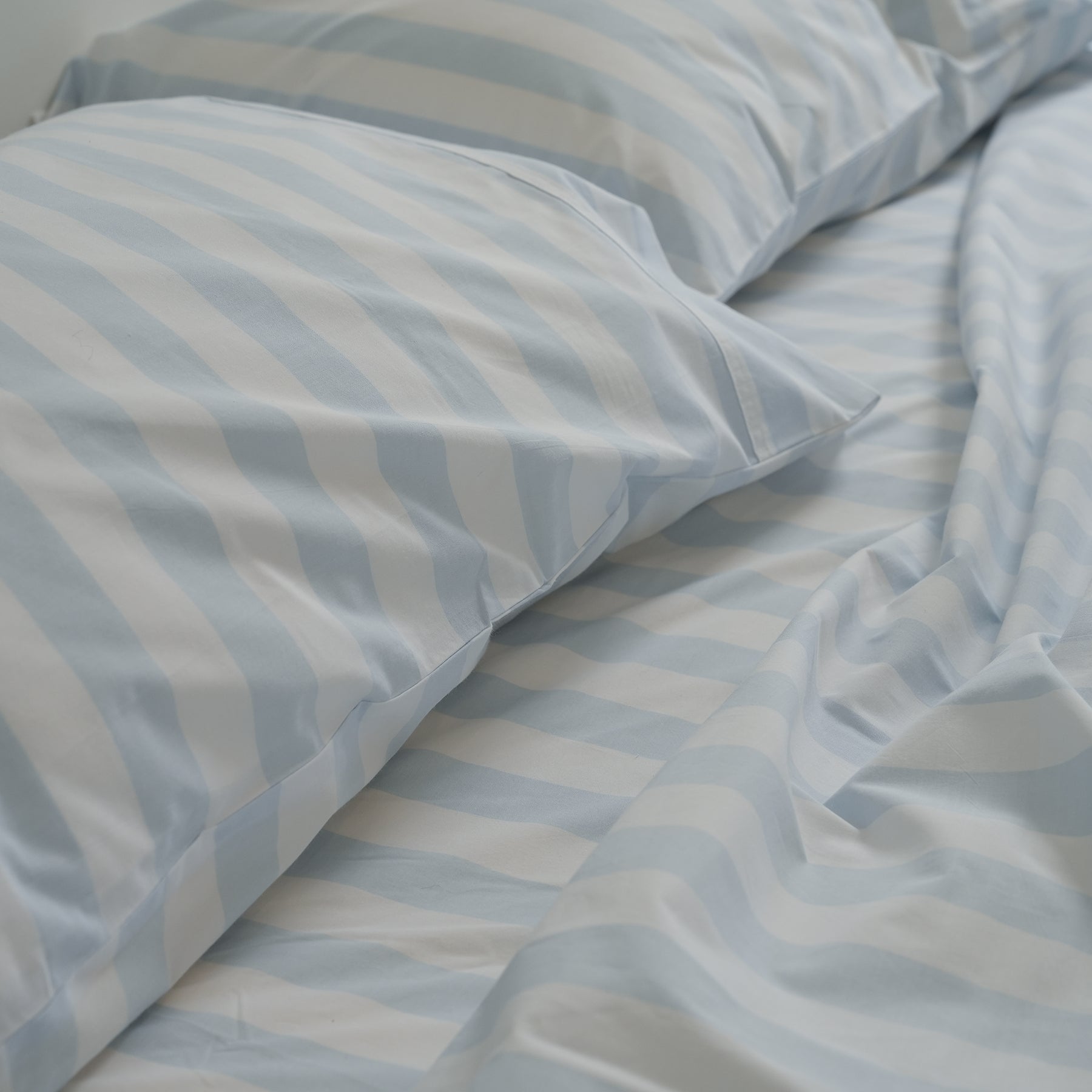 100% stonewashed cotton sheet set in sky blue stripe, close-up