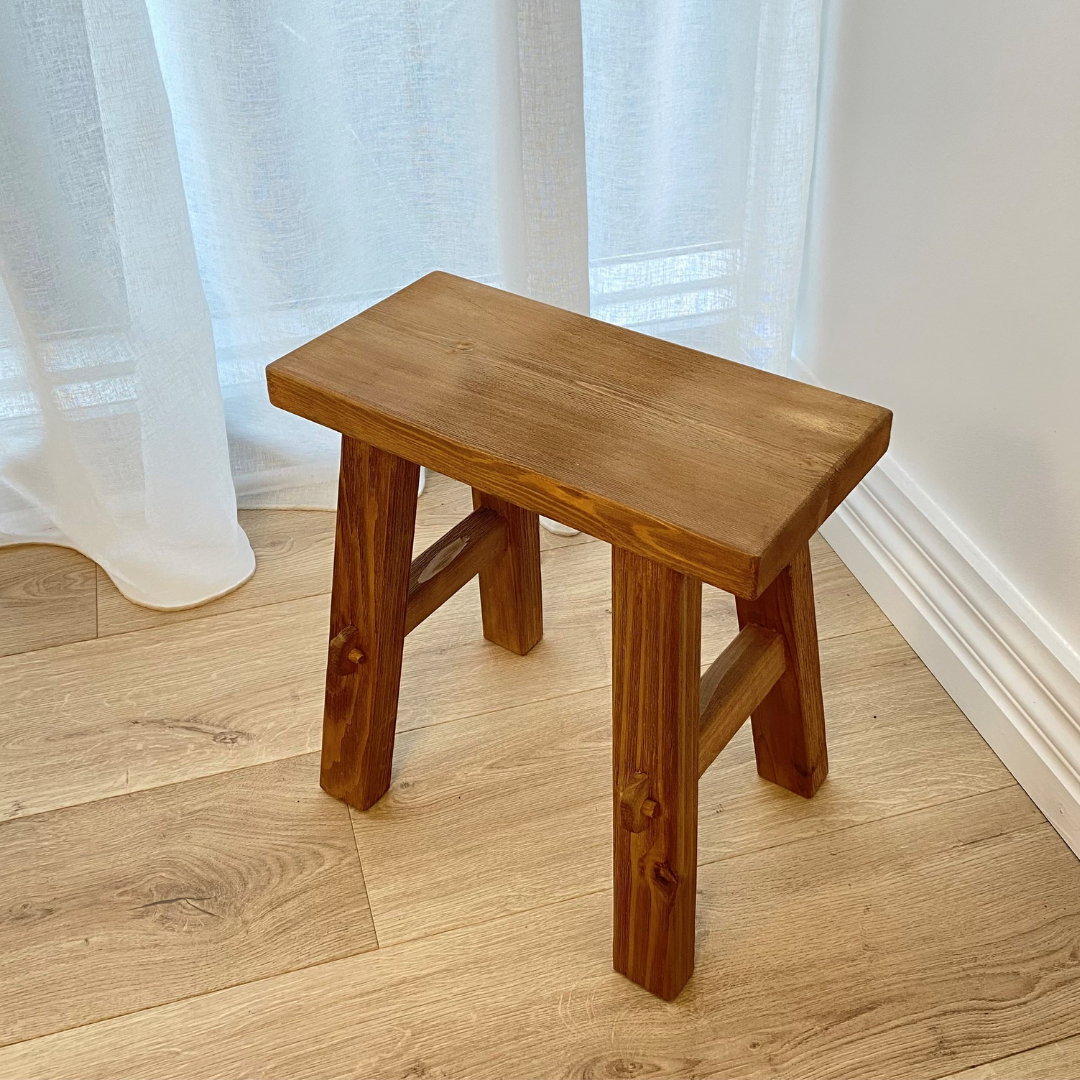 Small reclaimed wood bench in natural, styled shot